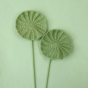 Close-up of handmade crochet lotus leaves with detailed green knitted textures