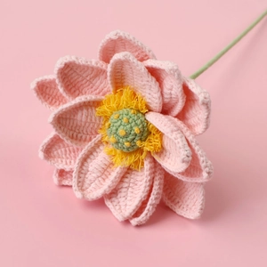 Detail of handmade crocheted pink lotus flower showing intricate yarn textures and petals