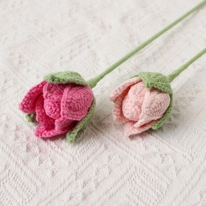 Macro detail of hand-knitted pink crochet roses showing intricate yarn textures