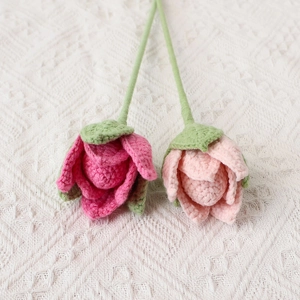 Handmade crochet rose bouquet with pink blossoms and green stems for home decor
