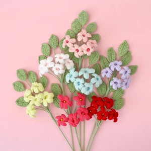 Handmade crochet flower bouquet in vibrant colors on a soft pink background