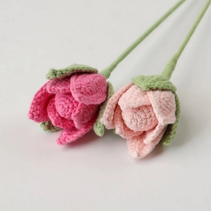 Detail of handmade crochet rose bouquet with delicate pink petals and green sepals