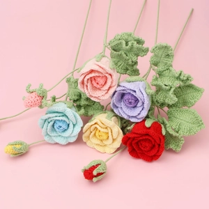 Close-up of handmade crochet roses in various colors showing detailed woven textures