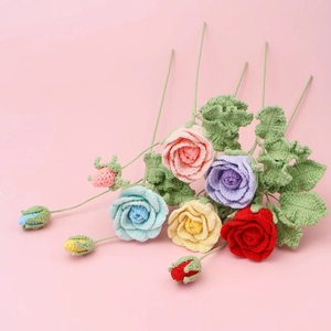 Detailed view of handmade crochet rose bouquet with colorful knitted flowers and green leaves