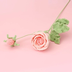 Detail of handmade crochet pink rose bouquet with intricate knitted texture and leaves