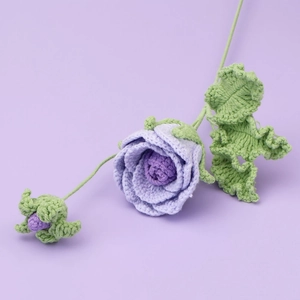 Detail of handmade crochet purple rose bouquet with knitted petals and green leaves
