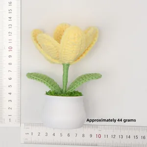 Detail of yellow knitted tulip in white pot showing weight of 44g and scale measurements