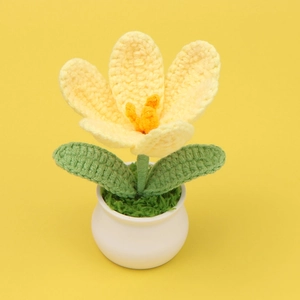Detailed view of hand-crocheted yellow tulip flower in a white ceramic pot ornament
