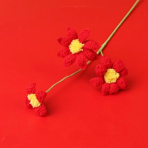 Handmade crochet bouquet featuring three red knitted daisies on a green stem decoration