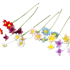 Handmade crochet flowers with multiple colorful petals and flexible green stems