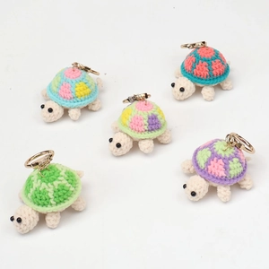 Set of five handmade crochet turtle keychains in various vibrant colors for bag charm