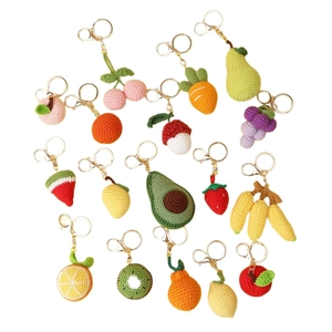 Handmade crochet fruit keychains with various styles like peach, grape and avocado charms