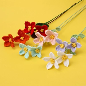 Handmade crochet flowers in six colors for home decor on a bright yellow background