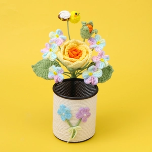 Handmade crochet flower pen holder featuring yellow rose and bee on a white woven base