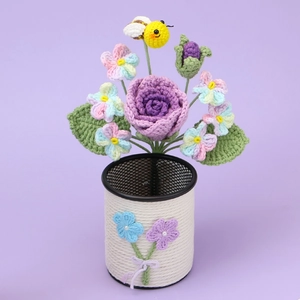 Handmade crochet flower bouquet in a white pen holder with purple rose and a bee