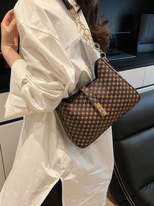 French retro printed shoulder bag with gold chain and floral pattern on white shirt