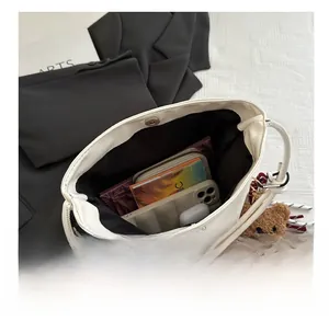 Top view of cream bucket bag interior showing large capacity and internal compartments
