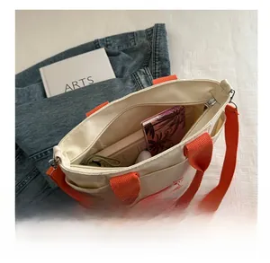 Spacious interior of canvas tote bag with orange straps and cute bear illustration