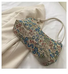 Close-up of floral jacquard fabric and knot handle detail of the bohemian shoulder bag