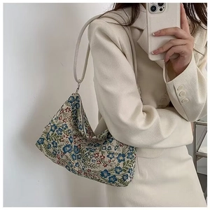 Detail of vintage floral jacquard shoulder bag featuring colorful woven embroidery
