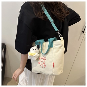 Back view of a casual canvas crossbody bag with contrast straps and panda plush charm