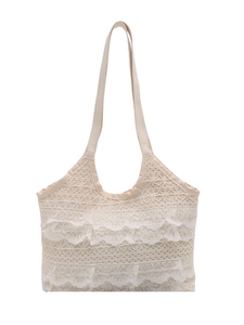 Elegant cream lace tote bag with tiered ruffle layers for a bohemian summer look