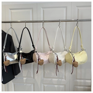 Five cylinder shoulder bags in various colors with cute bear charms and knotted straps