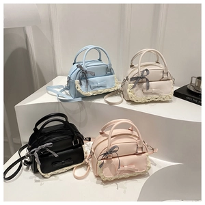 Group view of pastel shell handbags in blue, beige, black, and pink with lace bow detail