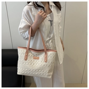 Detail of the white lace crochet tote bag with pink leather strap and brand label