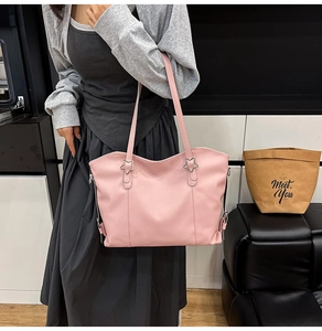 Close-up of pink tote bag featuring a silver star buckle and smooth faux leather finish
