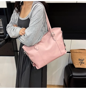 Detail view of pink soft leather tote bag with star ornament for commuting women