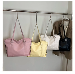 Detail of colorful soft leather tote bags with silver star buckles and shoulder straps