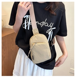 Sac bandoulière kaki porté avec doubles poches zippées et bandoulière large ajustable