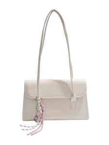 French baguette shoulder bag in cream leather with woven edges and decorative charms