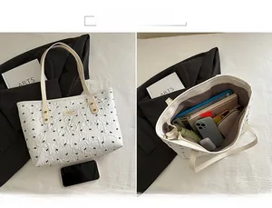Detail showing the large interior capacity and polka dot texture of this tote bag