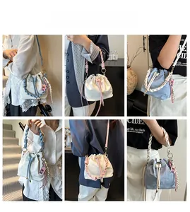 Detail of drawstring bucket bags with cloud texture, braided handles and cartoon charms