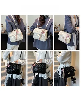 Detail showing classic quilted texture tote bag with metal twist lock and silk scarf detail