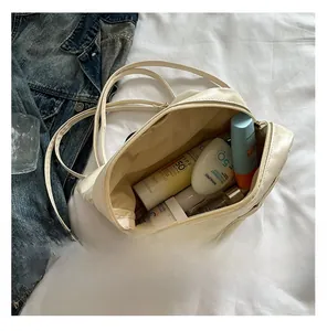 Interior view showing the large capacity for skincare items in a beige quilted tote bag