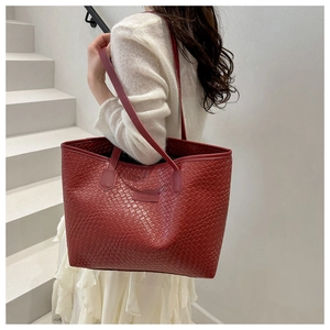 Detail of red woven tote bag showing dense texture and PANYISSA BAGS leather label