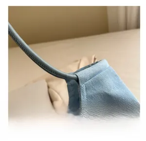 Detailed close-up showing the neat stitching and fabric texture of a blue canvas tote bag