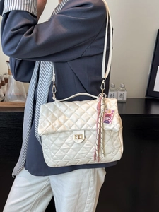 White quilted rhombic shoulder bag with gold twist lock and tassel charm for women