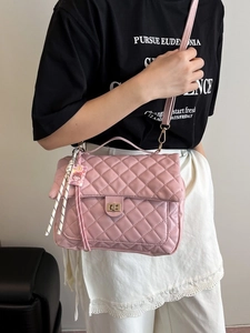 Pink quilted leather backpack with gold rotary lock and charm for daily commute