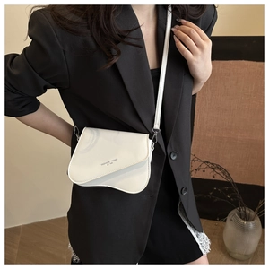 On-body view of white saddle crossbody bag featuring Fashion Trend lettering print
