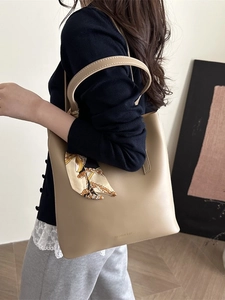 Borsa tote minimalista in pelle beige con foulard vintage indossata a spalla dal modello