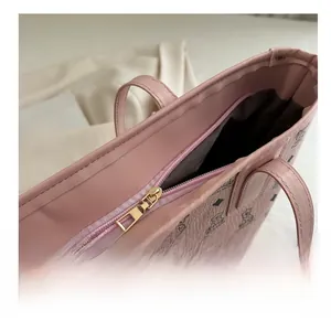 Detail of a pink tote bag showing the gold zipper and vintage bear pattern prints