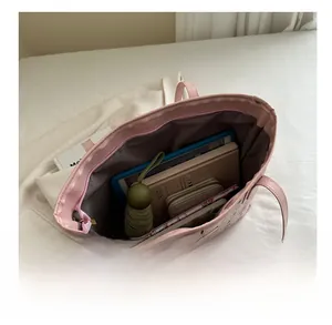 Pink tote bag interior showing large capacity for laptop, umbrella and daily essentials