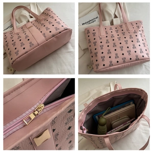 Detail view of pink tote bag with bear pattern, zipper closure and large capacity