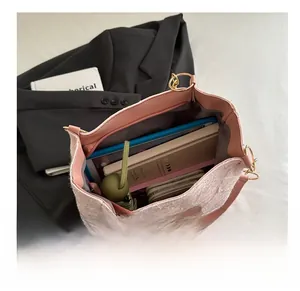 Top view of pink canvas tote bag showing spacious interior with various daily items