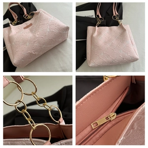 Close-up of floral embroidery on pink tote bag with golden chain and inner pocket