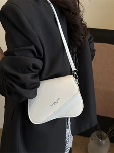 Minimalist cream white crossbody bag with curved base and black fashion lettering logo